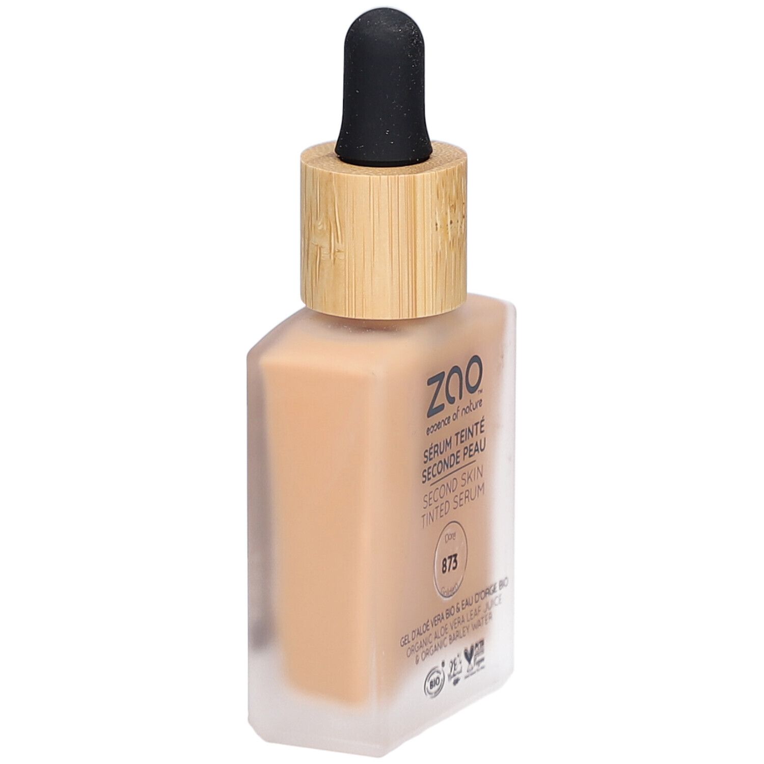Sérum teinté dans un flacon carré en verre avec bouchon en bambou et pipette. Inscription : ZAO, Sérum Teinté Seconde Peau 873 Doré.