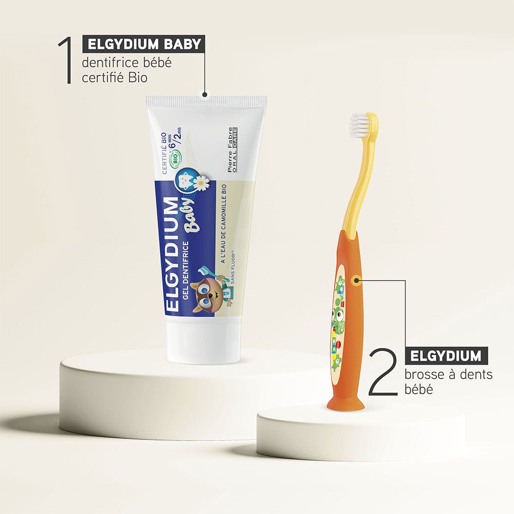 Gel dentifrice ELGYDIUM Baby et brosse à dents bébé. Sur socle. Gel avec certification Bio. Brosse orange-jaune.
