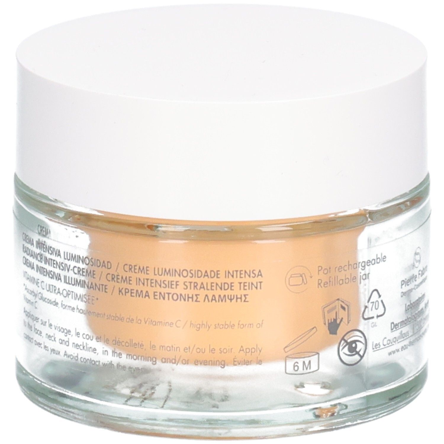Pot en verre avec couvercle blanc. Dos avec texte et symboles. Contenu orangé. Inscription: Crème Intensive Luminosidad.