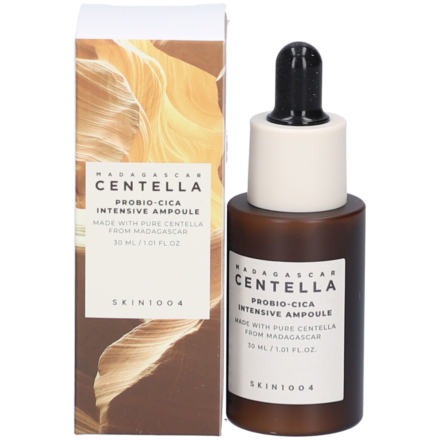 Flacon de sérum et emballage. Flacon brun avec bouchon noir et embout blanc. Texte.