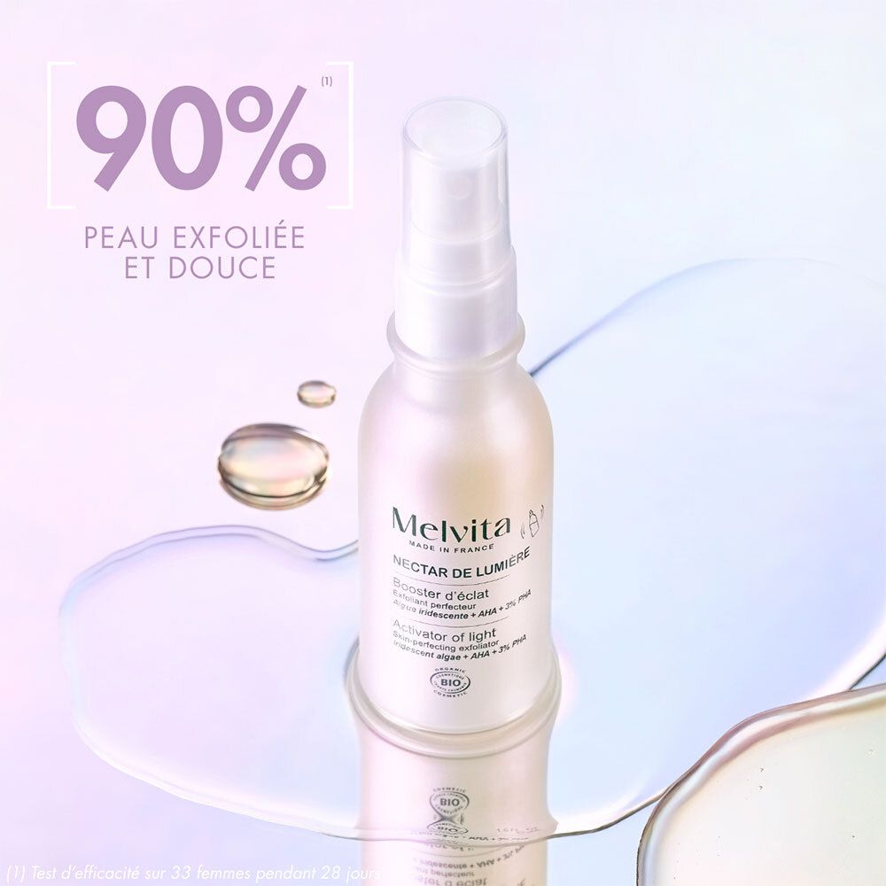 Flacon avec vaporisateur sur surface miroir. Texte : 90% Peau exfoliée et douce. Melvita, Nectar de Lumière.