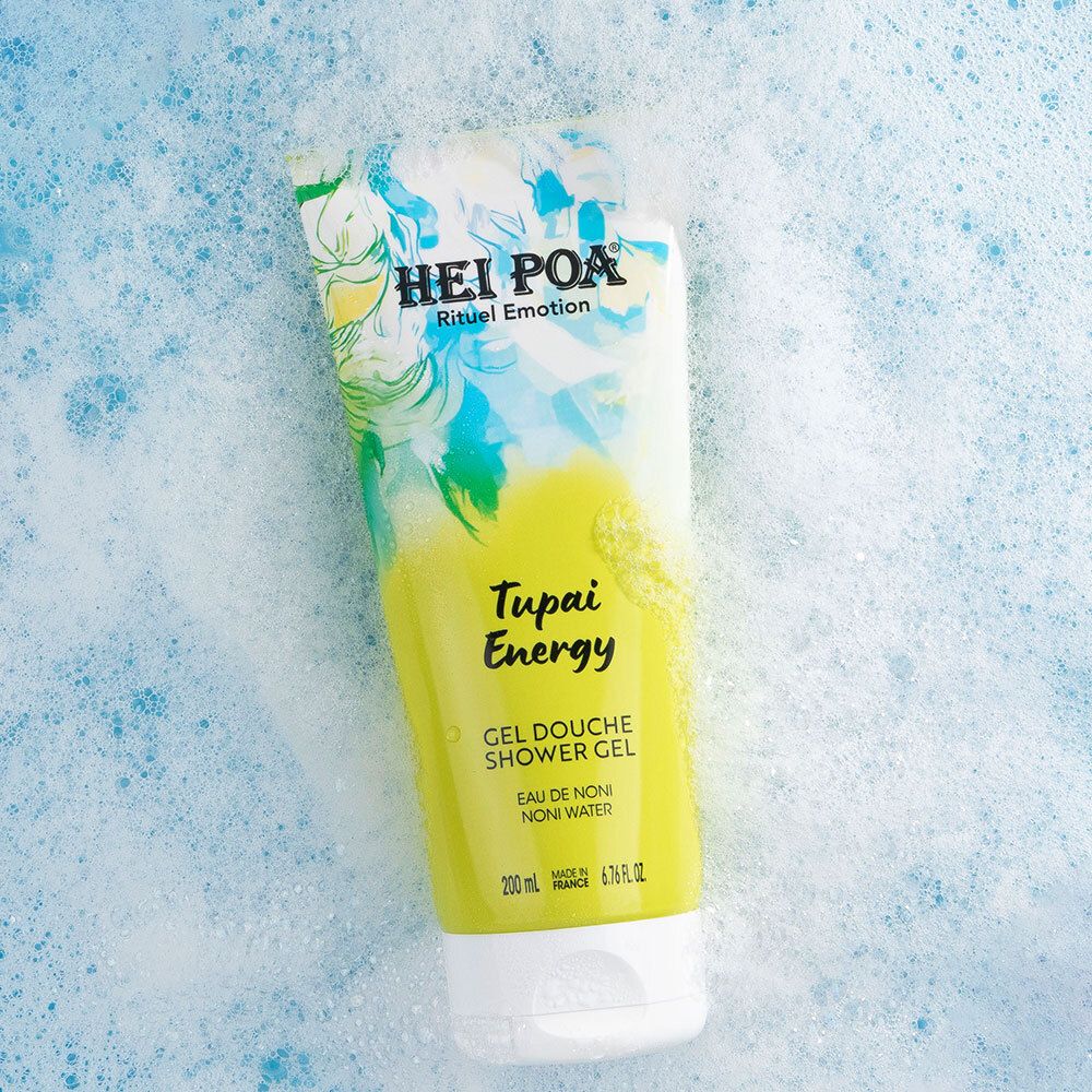 Tube de gel douche Hei Poa Tupai Energy dans de la mousse sur fond bleu.