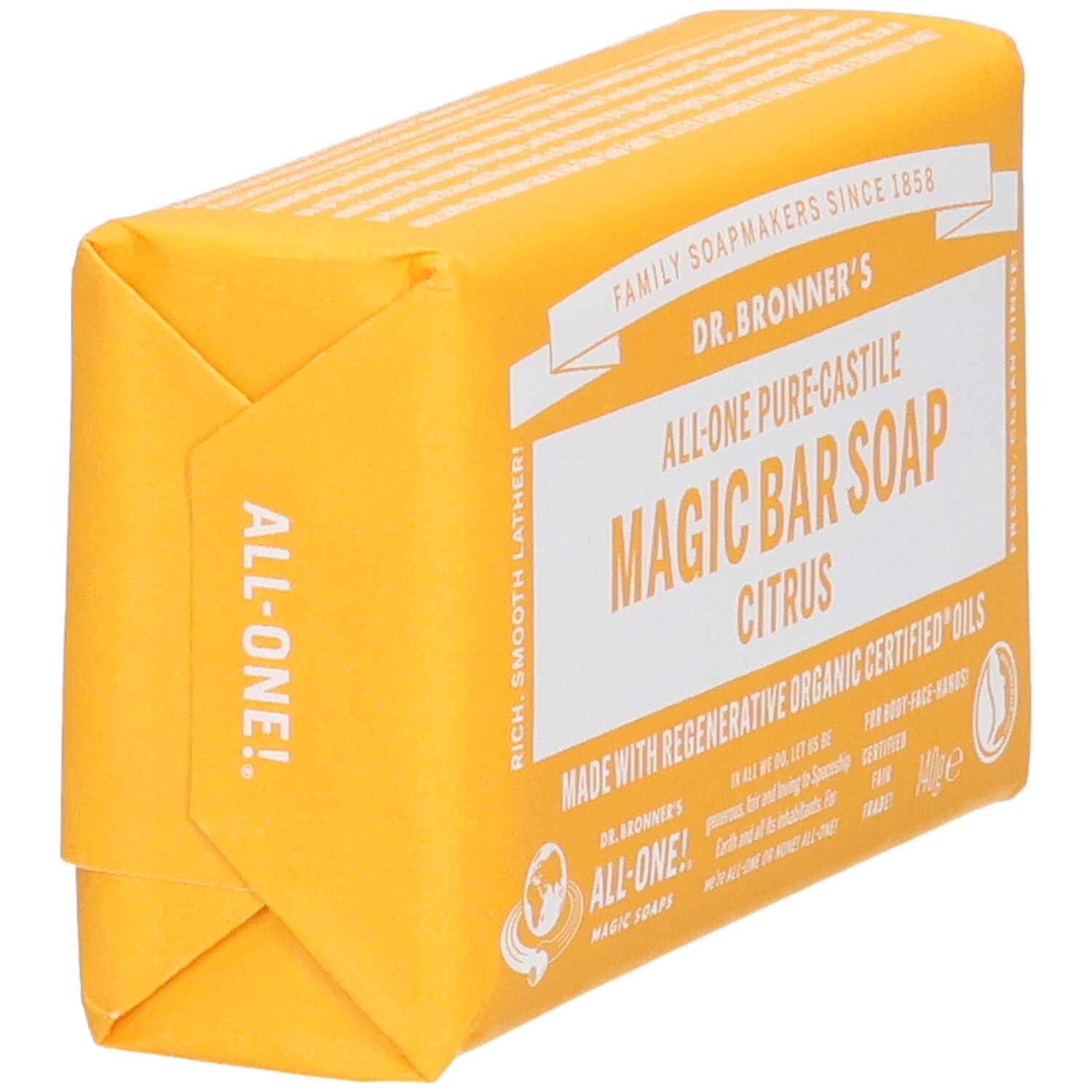 Pain de savon jaune emballé. Inscription: Dr. Bronner's Magic Bar Soap Citrus. Vue en biais.
