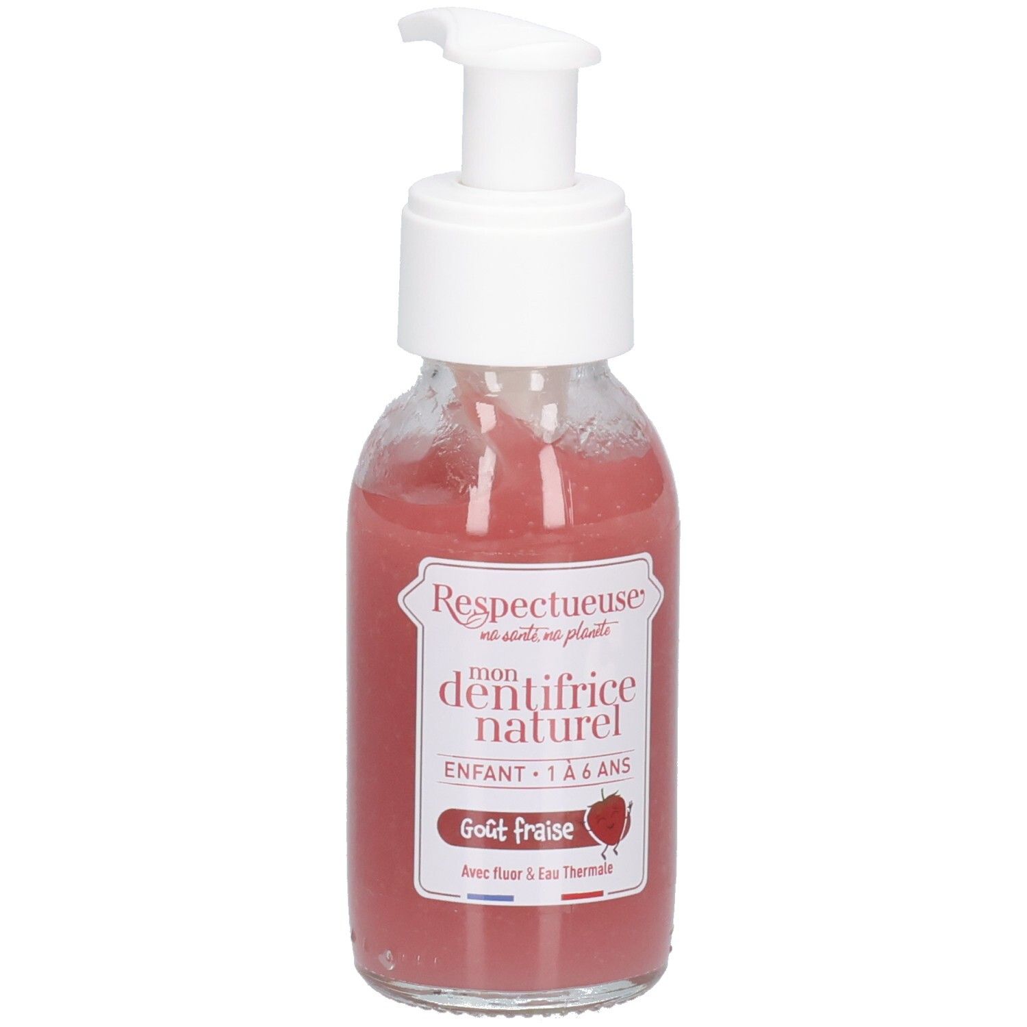 Flacon en verre avec pompe blanche, contenant un liquide rose. Étiquettes: "Respectueuse", "dentifrice naturel", "Goût fraise".