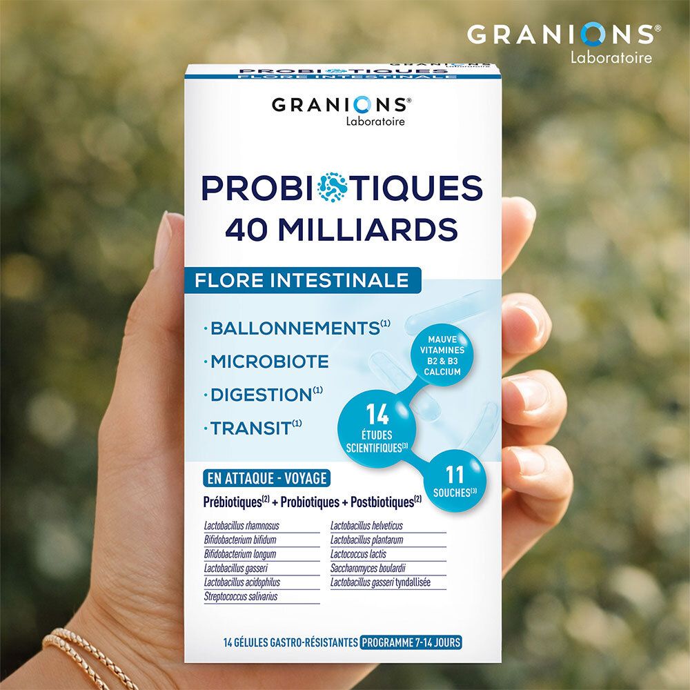 Main tenant une boîte de GRANIONS PROBIOTIQUES. Inscription : PROBIOTIQUES 40 MILLIARDS, Flore Intestinale. 14 gélules.