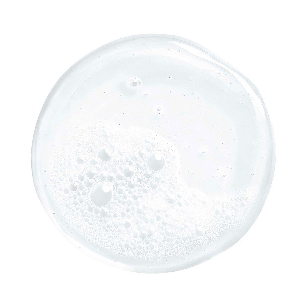 Goutte circulaire de liquide transparent et moussant. Bulles visibles.