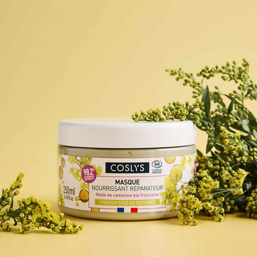Pot de crème blanc. Inscription: Coslys Masque nourrissant réparateur. 250ml. Décoré de fleurs jaunes.
