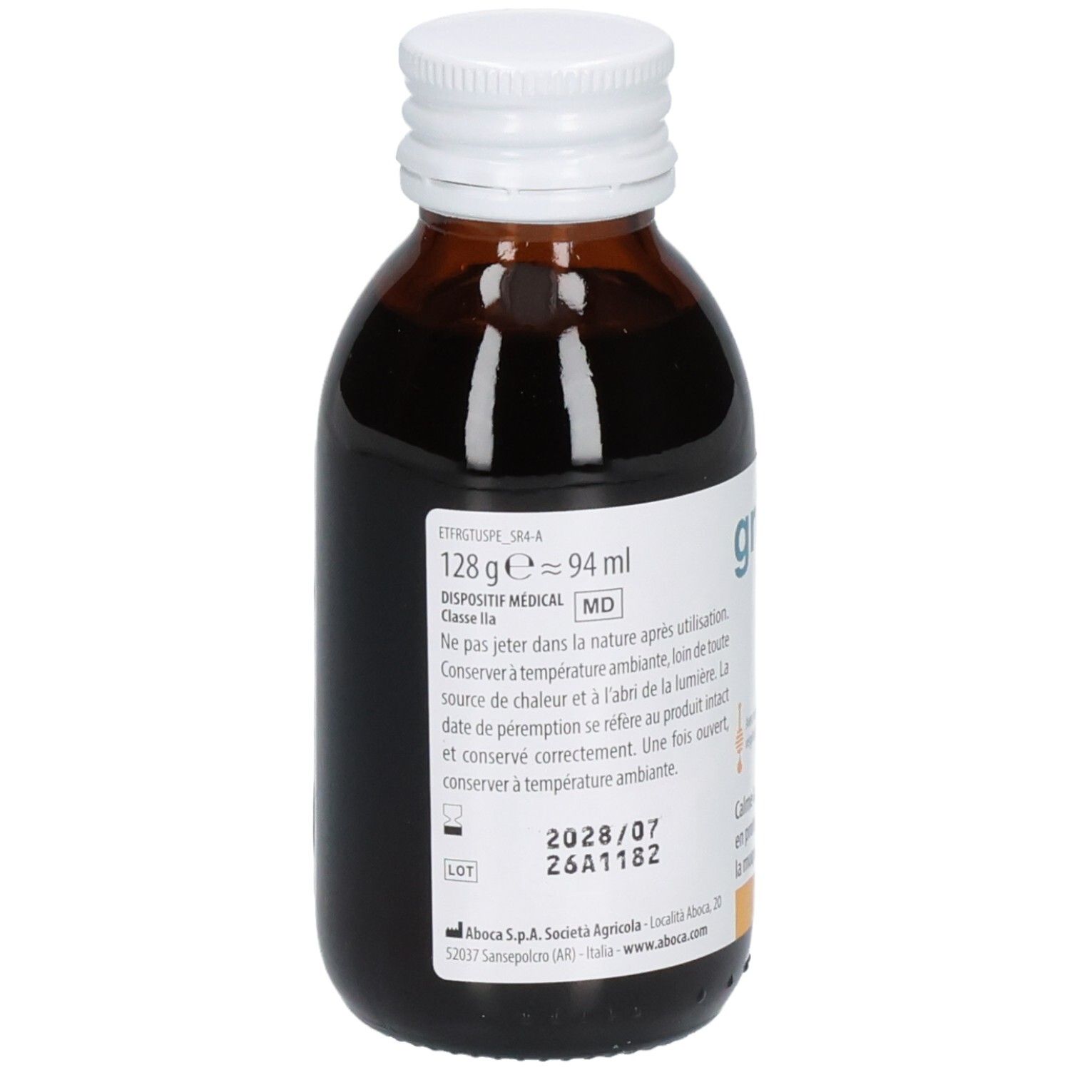 Gros plan d'une bouteille en verre brun avec sirop foncé. Étiquette avec informations produit, numéro de lot et date de péremption.