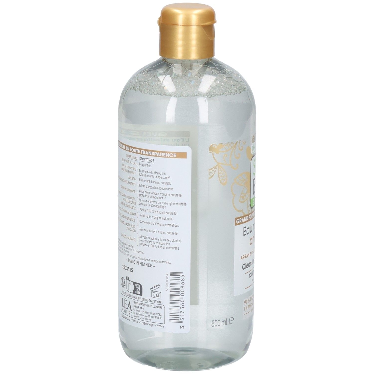 Vue arrière du flacon. Étiquette avec texte. Bouchon doré. Liquide transparent visible.