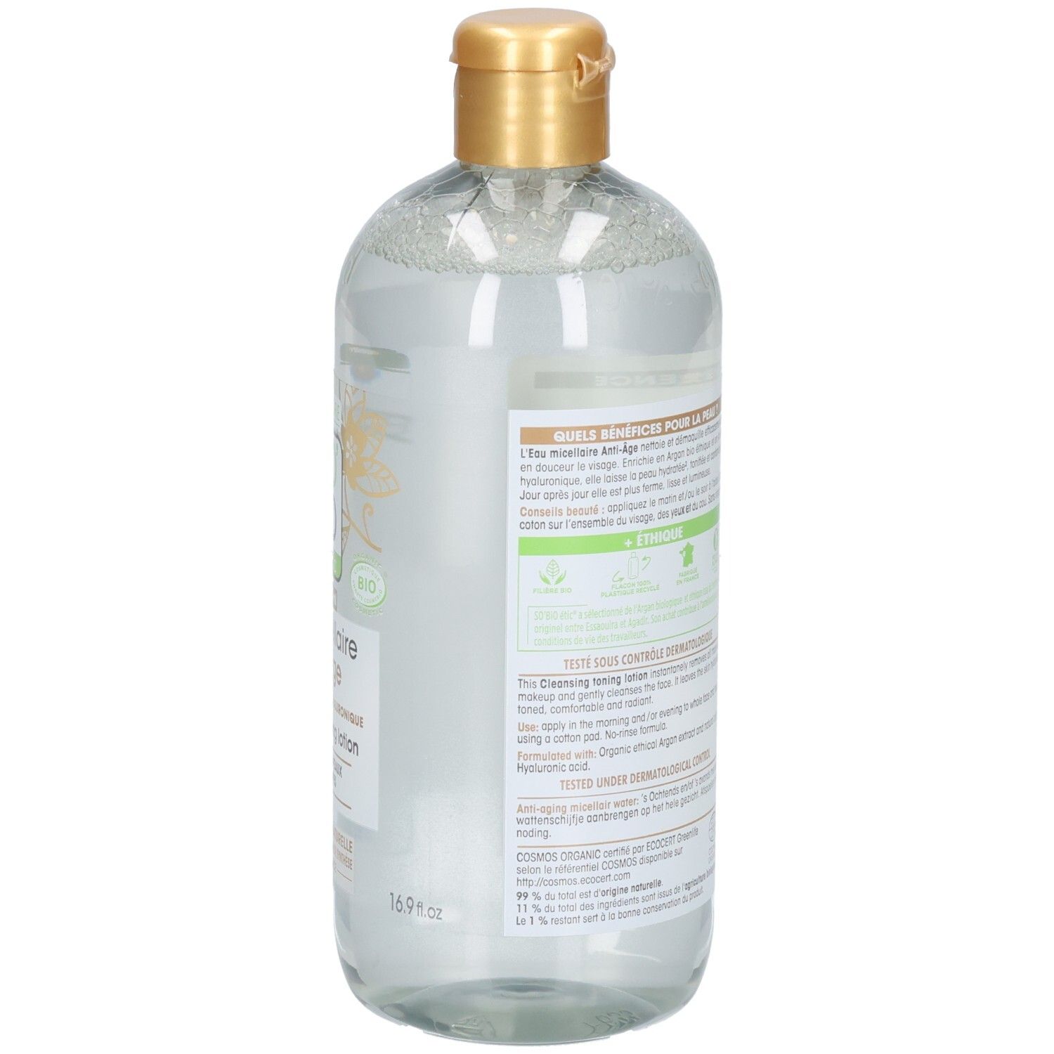 Vue arrière du flacon. Étiquette avec texte. Bouchon doré. Liquide transparent visible.