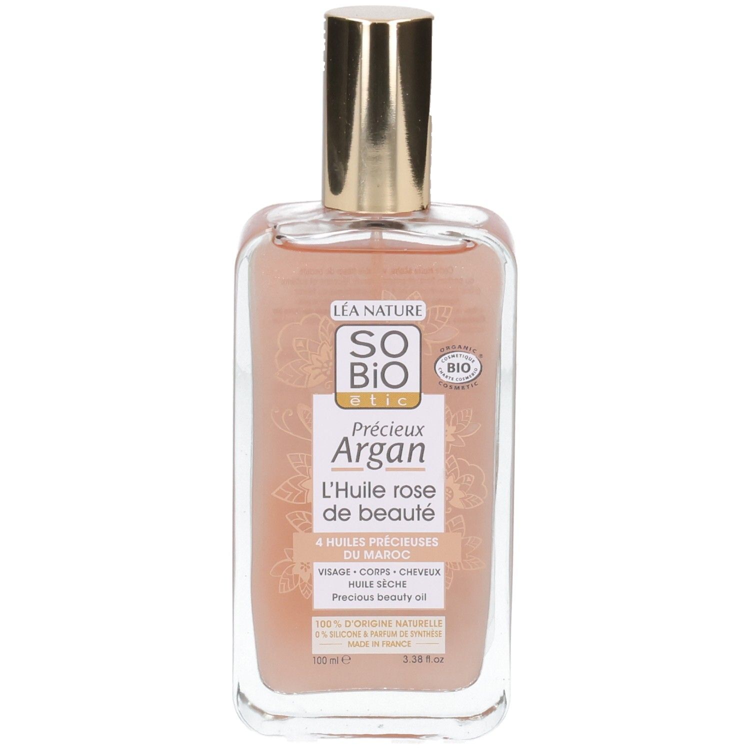 Flacon transparent avec bouchon doré. Étiquette avec nom du produit et label bio. Liquide rosé visible.