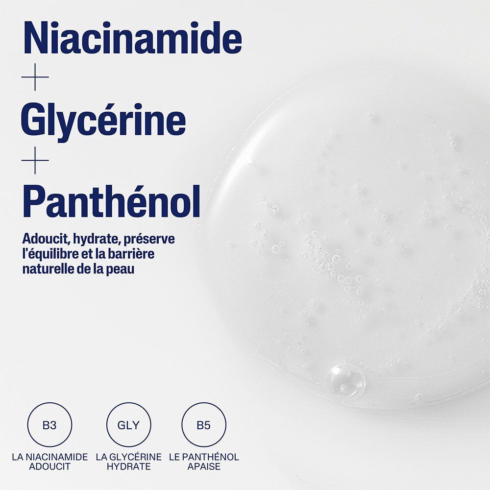 Gros plan sur un liquide avec texte: Niacinamide + Glycérine + Panthénol. Trois cercles avec lettres B3, GLY, B5.