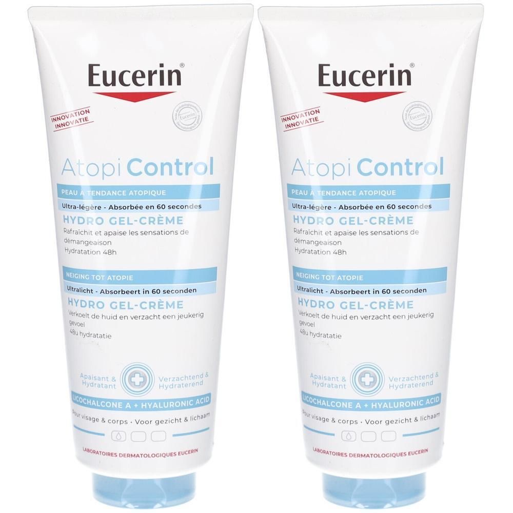 Deux tubes de Eucerin Atopi Control Hydro Gel-Crème. Tubes blancs avec texte bleu et bouchons bleus. Texte en allemand, français et néerlandais.