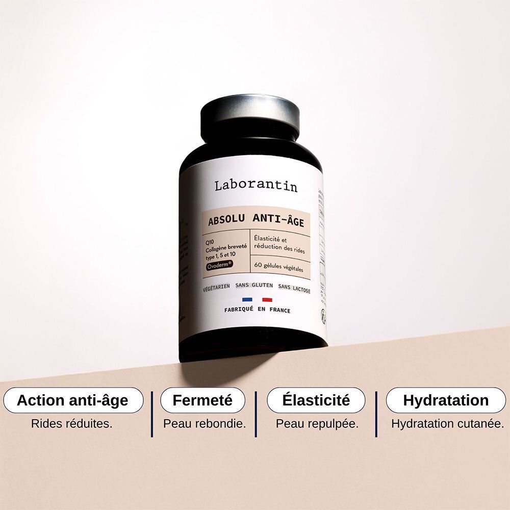 Flacon Laborantin Absolu Anti-Âge. Flacon noir, couvercle argenté. Texte: Action anti-âge, Fermeté, Élasiticité, Hydratation.