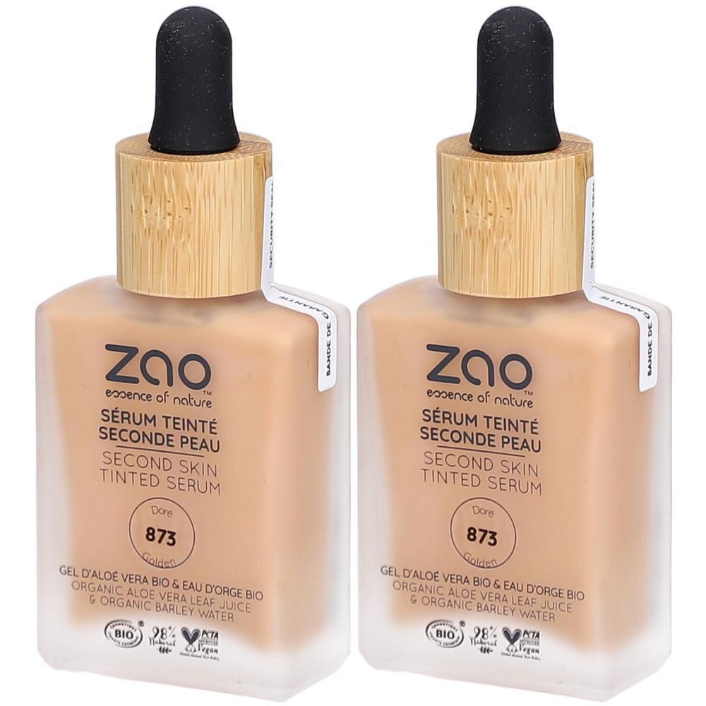 Deux flacons de ZAO Sérum Teinté Seconde Peau 873 Doré. Flacons en verre avec bouchon bambou et pipette. Inscriptions: BIO, Vegan.
