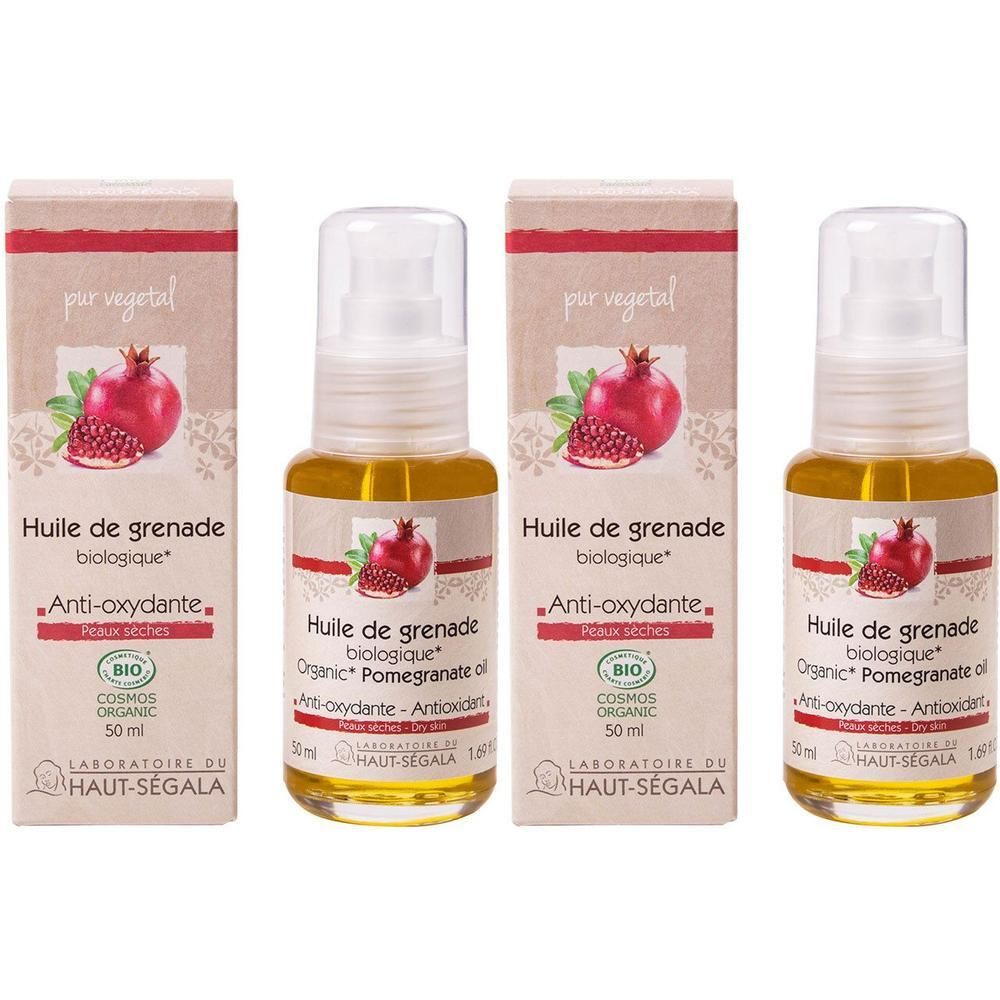 Trois flacons et emballages. Inscription: Huile de grenade biologique, Anti-oxydante, BIO COSMOS ORGANIC. Illustration de grenade.