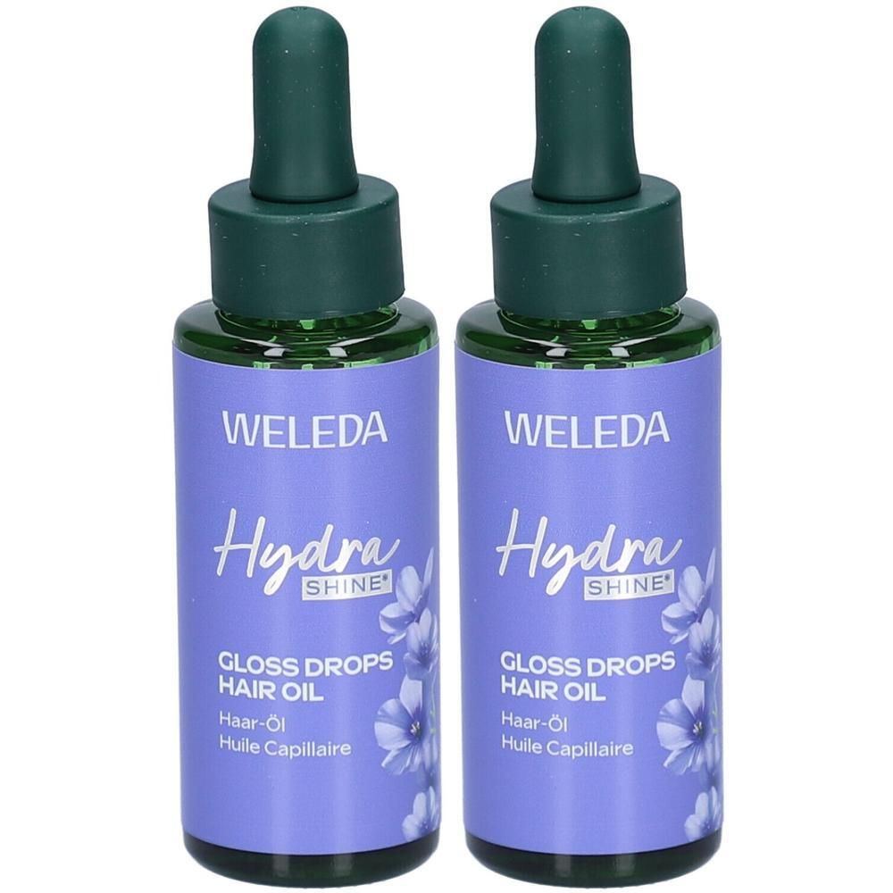 Deux flacons avec bouchons et pipettes verts. Les étiquettes violettes indiquent "WELEDA Hydra SHINE" et "GLOSS DROPS HAIR OIL".