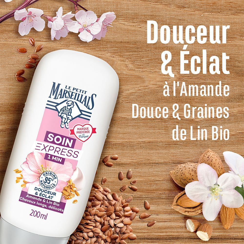 Flacon avec étiquette rose. Inscription : Le Petit Marseillais, Soin Express 1 Min, Douceur & Éclat, Amande & Lin Bio. Amandes et graines de lin.