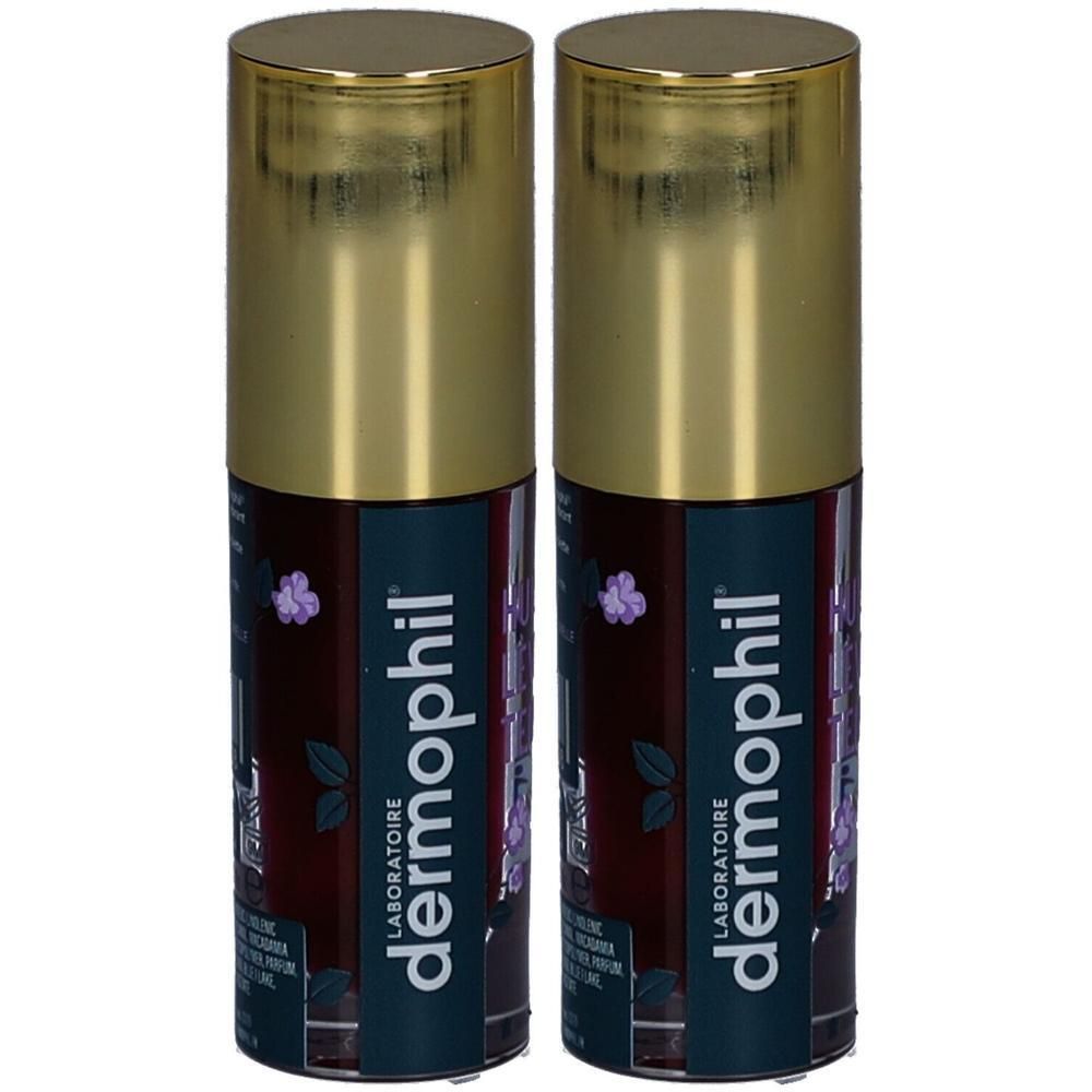 Deux flacons cylindriques avec bouchons dorés. L'étiquette porte la mention "dermo phil".