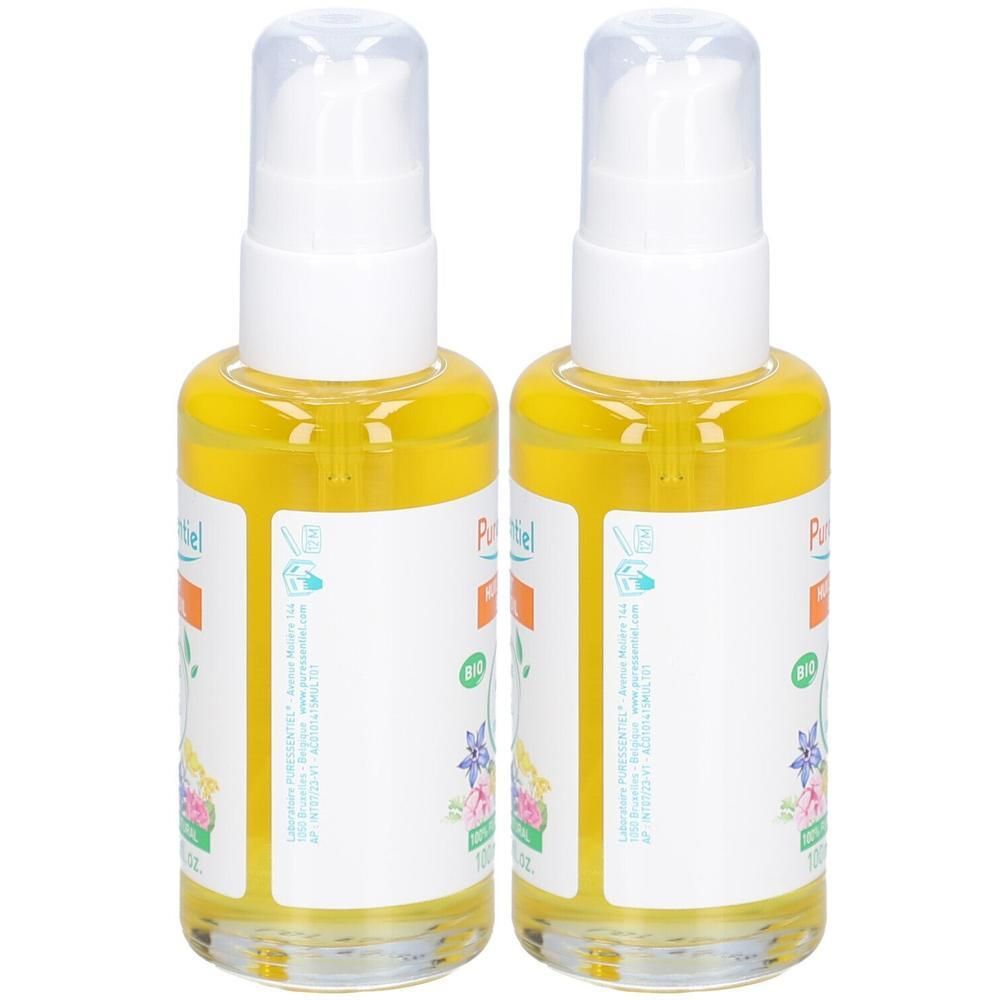 Deux flacons avec liquide jaune et pompes blanches. Étiquettes avec texte et illustrations florales.