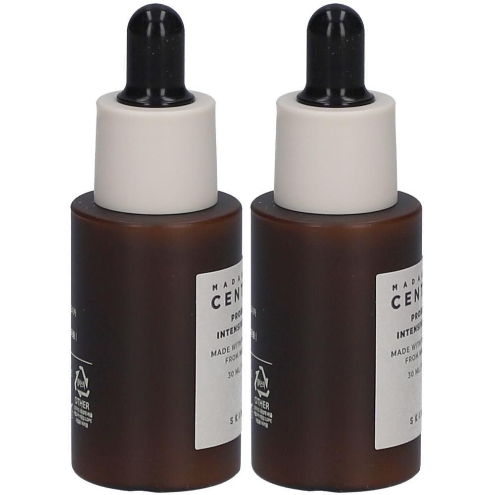 Deux flacons bruns avec pipettes noires. Étiquettes blanches avec texte. Symbole de certification papier. Flacons côte à côte.