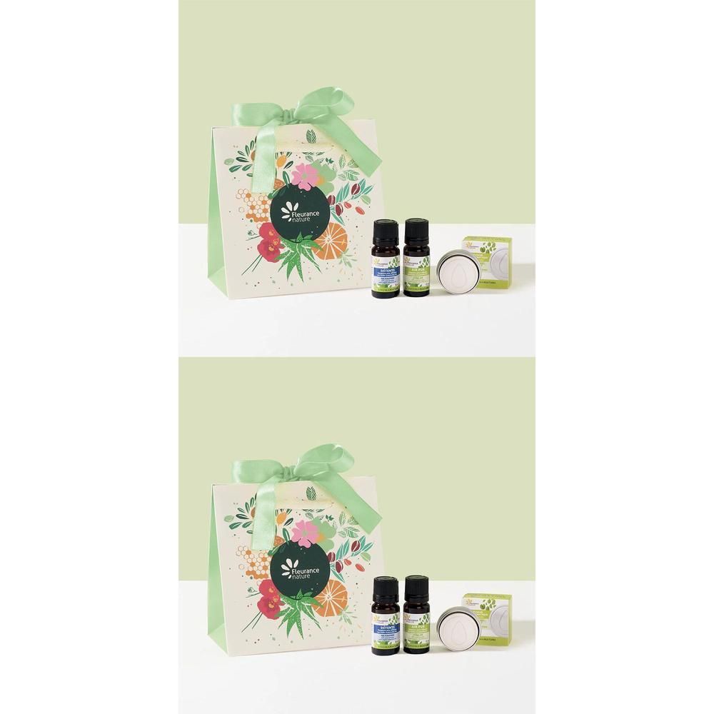 Coffret cadeau avec sac en papier, ruban, flacons et contenant. Le sac est imprimé de fleurs et de fruits.