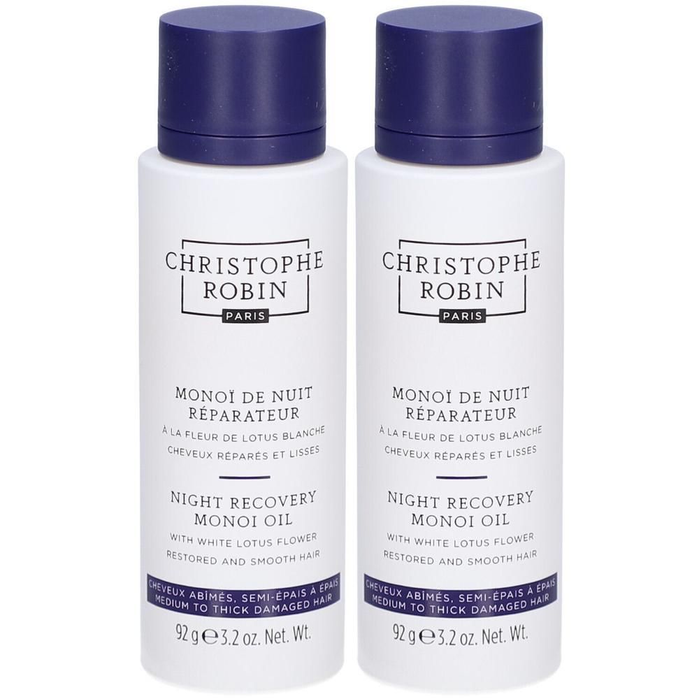 Deux flacons blancs avec bouchons bleus. Inscription: CHRISTOPHE ROBIN PARIS, MONOI DE NUIT RÉPARATEUR, NIGHT RECOVERY MONOI OIL.