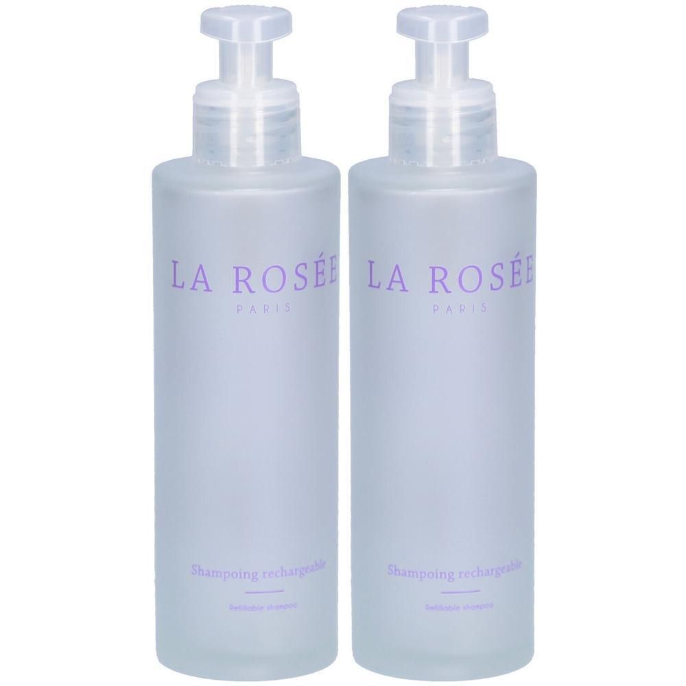 Deux flacons transparents avec pompe. Sur chaque flacon, l'inscription "LA ROSÉE PARIS" et "Shampoing rechargeable" en violet.
