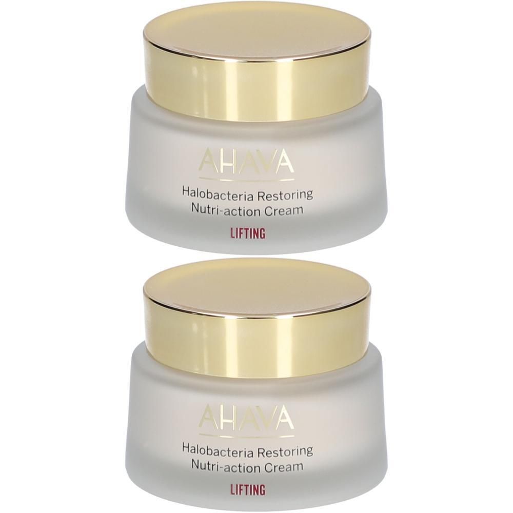 Deux pots de crème avec des couvercles dorés. On peut lire AHAVA, Halobacteria Restoring Nutri-action Cream et LIFTING sur les pots.