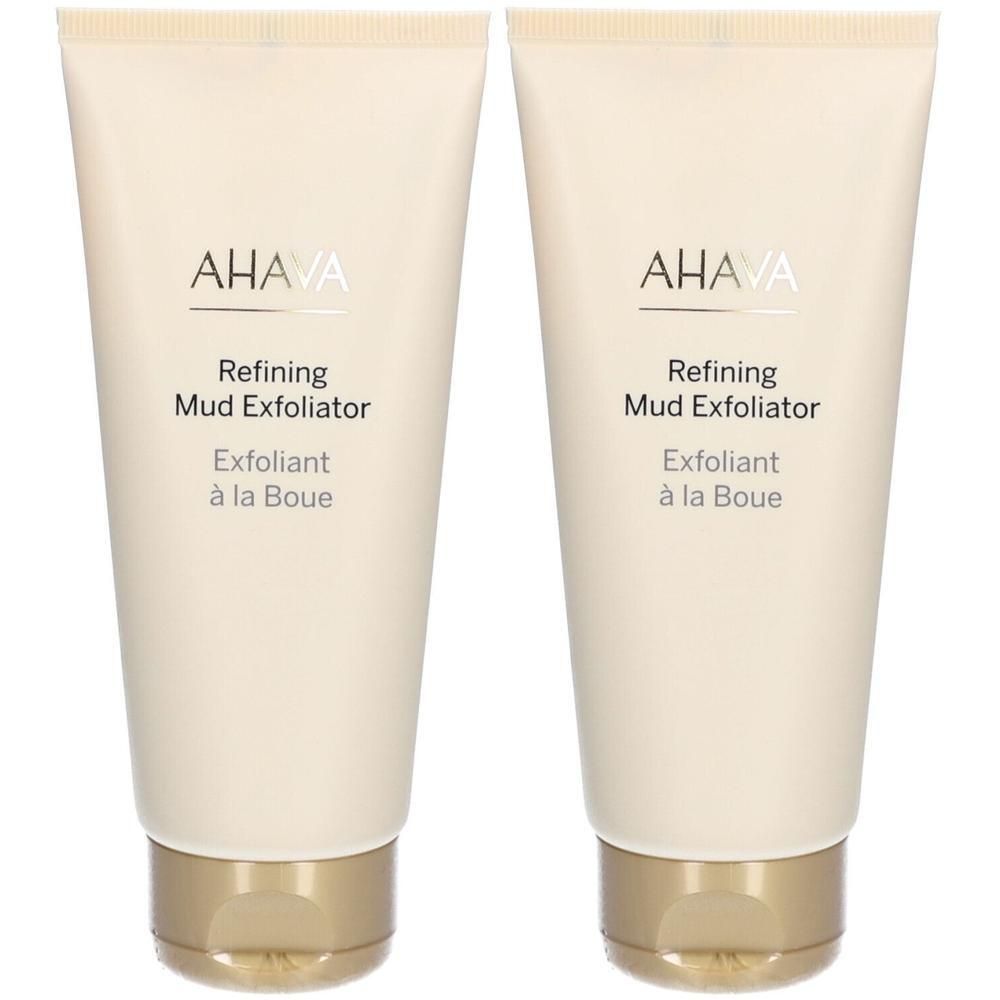 Deux tubes de AHAVA Refining Mud Exfoliator. Tubes beiges avec bouchons dorés. Inscriptions noires.