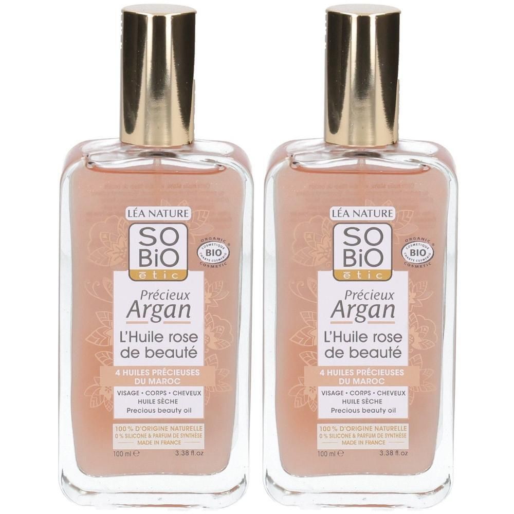 Deux flacons de So Bio Etic Précieux Argan L'Huile Rose de Beauté. Flacons transparents avec bouchons dorés et étiquettes.
