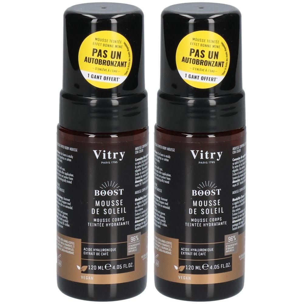Deux flacons de Vitry Boost Mousse de Soleil. Bouchon noir, autocollant jaune. Liquide brun. Texte: Boost, Mousse de Soleil, 120 ml.