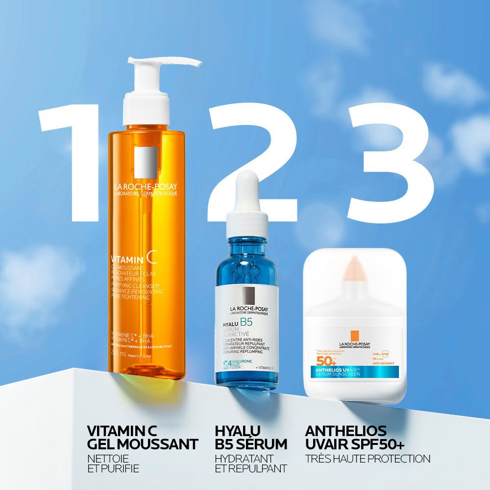 Trois produits. À gauche, flacon orange. Au centre, flacon bleu avec pipette. À droite, flacon blanc avec bouchon orange.