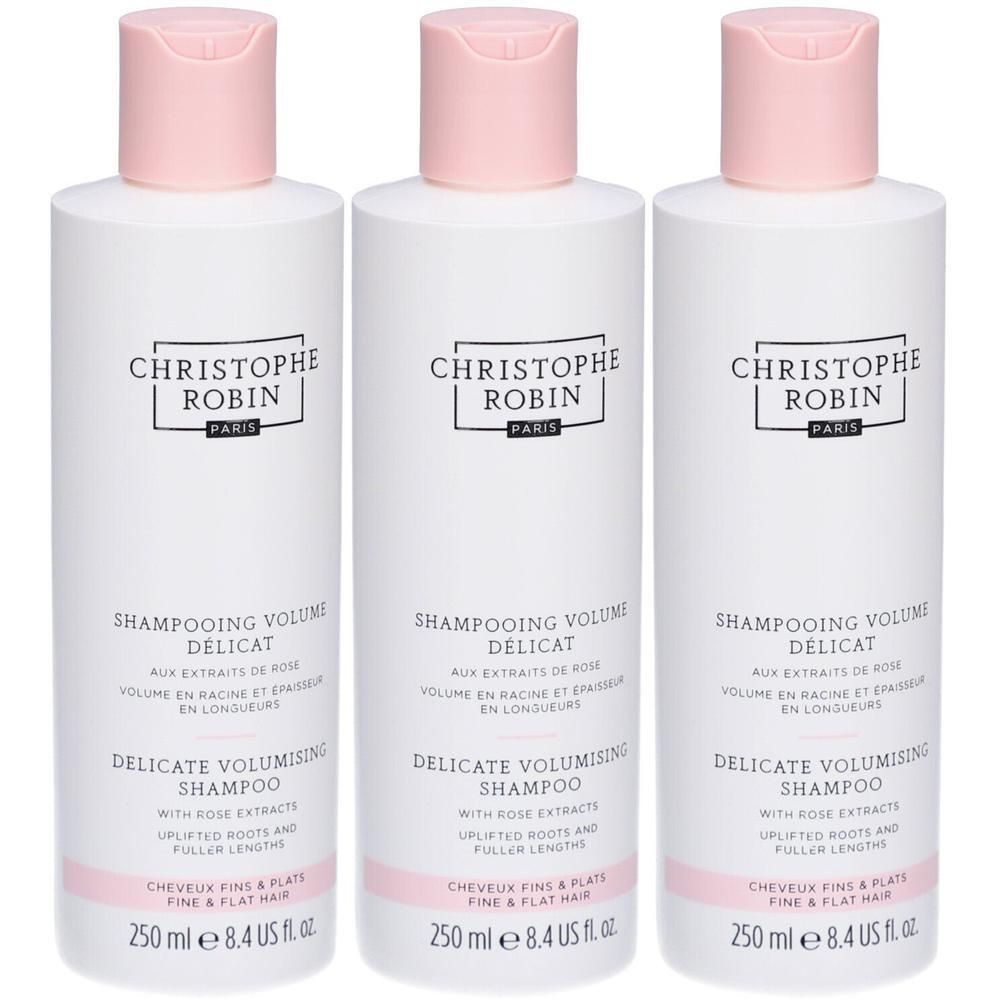 Trois flacons de shampooing blancs avec bouchons roses. Inscription : CHRISTOPHE ROBIN, SHAMPOOING VOLUME DELICAT, 250 ml.