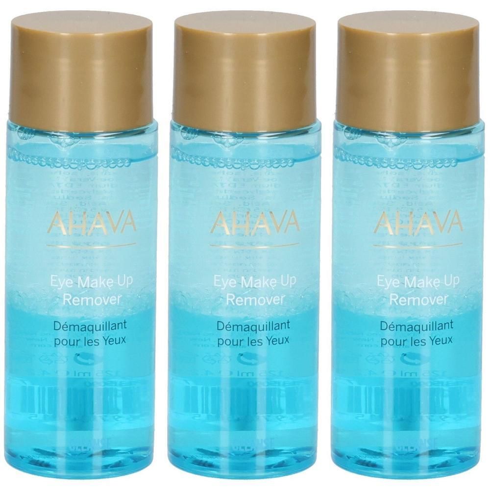 Trois flacons de démaquillant pour les yeux. Liquide clair dans des flacons cylindriques avec des bouchons dorés. Inscription: AHAVA, Eye Make Up Remover.