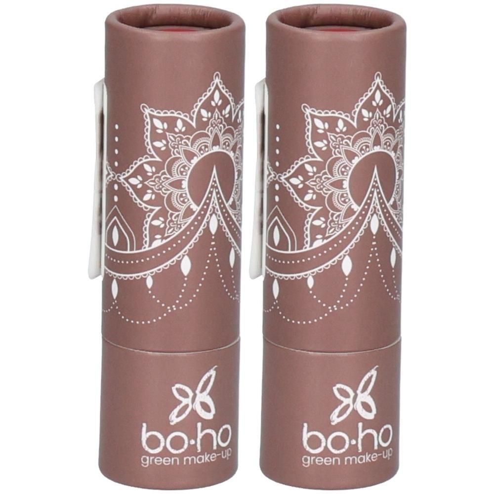 Deux emballages cylindriques bruns avec motif mandala blanc et texte « bo-ho green make-up ». Fermeture blanche.