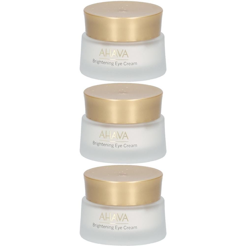 Trois pots de crème avec des couvercles dorés.  "AHAVA Brightening Eye Cream" est écrit sur les pots.