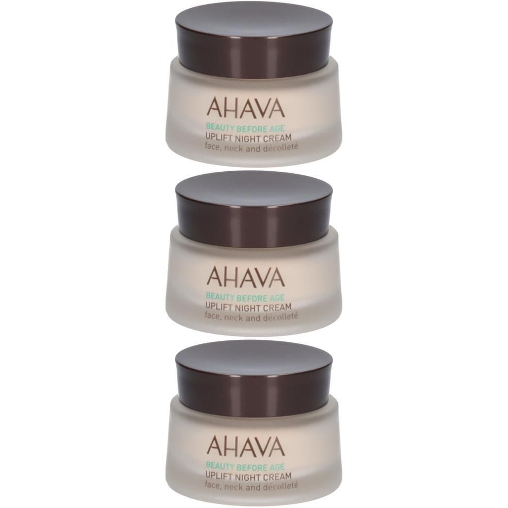Trois pots de crème de nuit AHAVA Uplift. Couvercle marron, verre crème. Inscription: AHAVA, Uplift Night Cream.