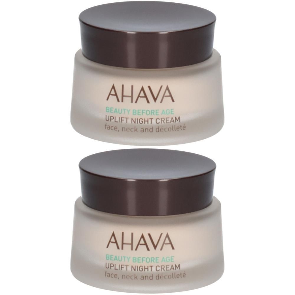 Deux pots de crème de nuit AHAVA. Récipients en verre avec couvercles marron. Inscription: UPLIFT NIGHT CREAM pour visage, cou et décolleté.