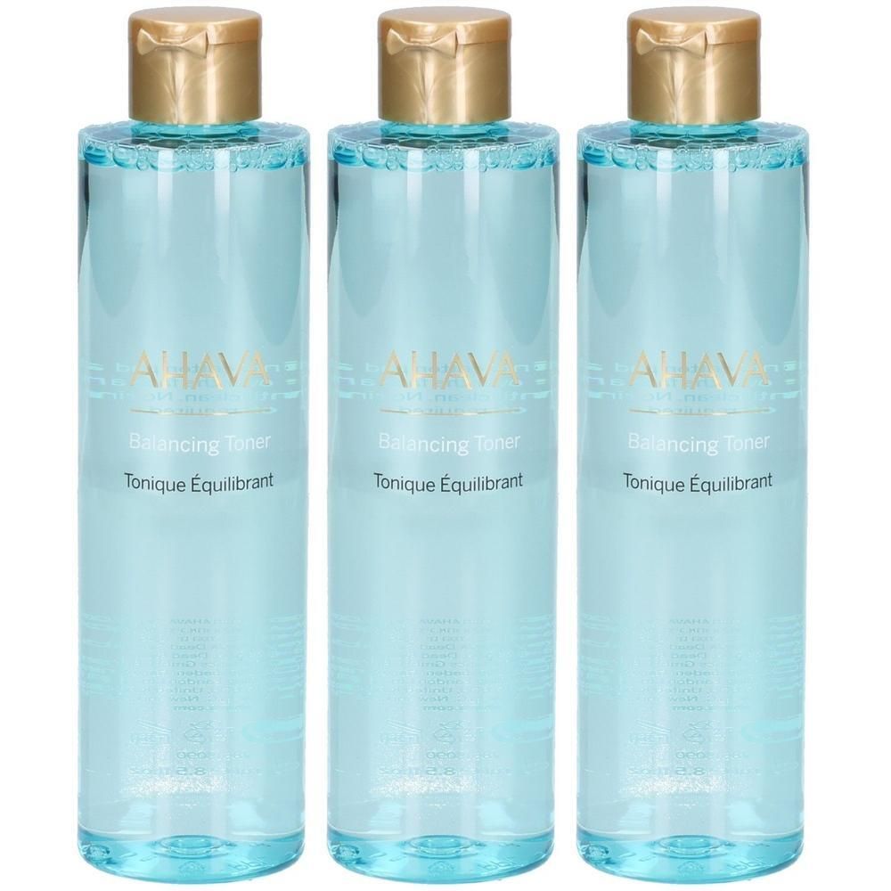 Trois flacons bleus avec bouchons dorés. Inscription: AHAVA, Balancing Toner, Tonique Équilibrant.