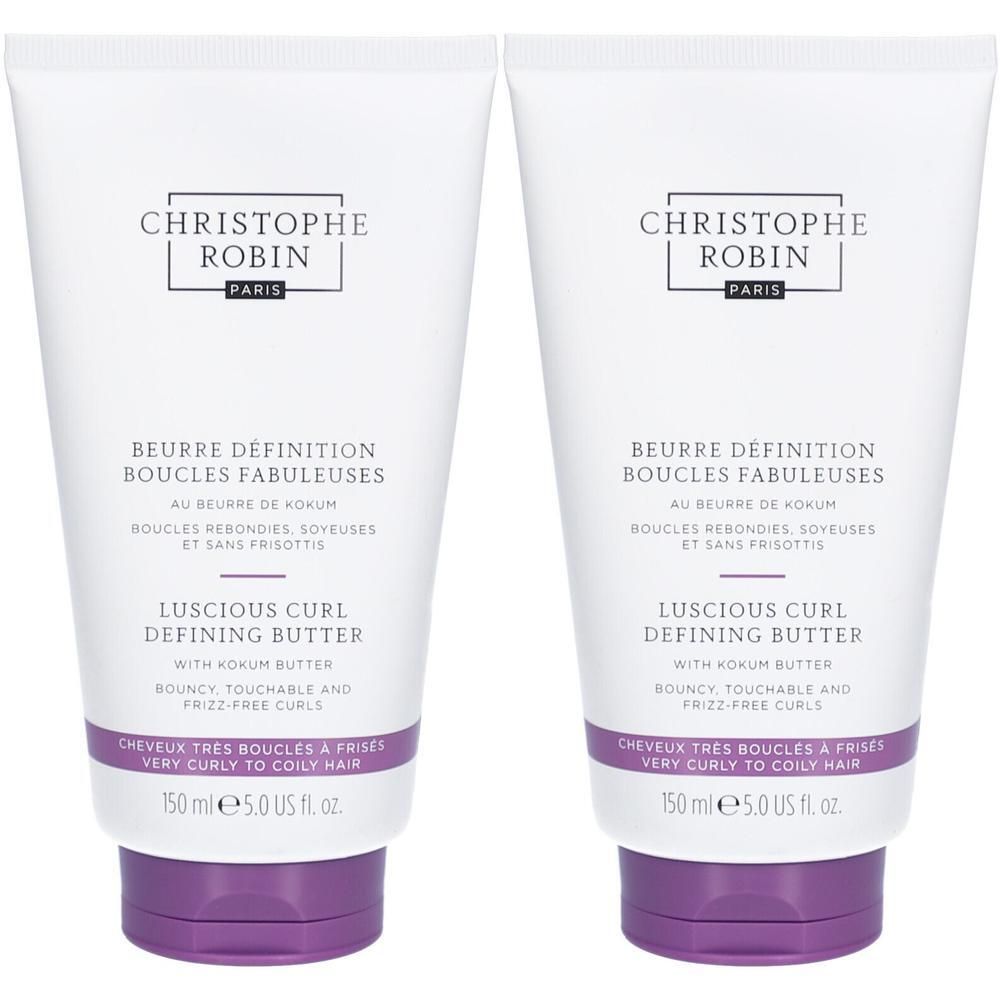 Deux tubes blancs. Inscription: CHRISTOPHE ROBIN PARIS, BEURRE DÉFINITION BOUCLES FABULEUSES, LUSCIOUS CURL DEFINING BUTTER. Fond violet.