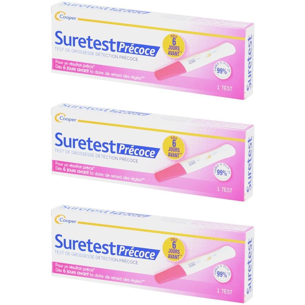 Trois boîtes de test de grossesse Suretest Précoce. Emballage rose et blanc. Contient une illustration de test de grossesse.