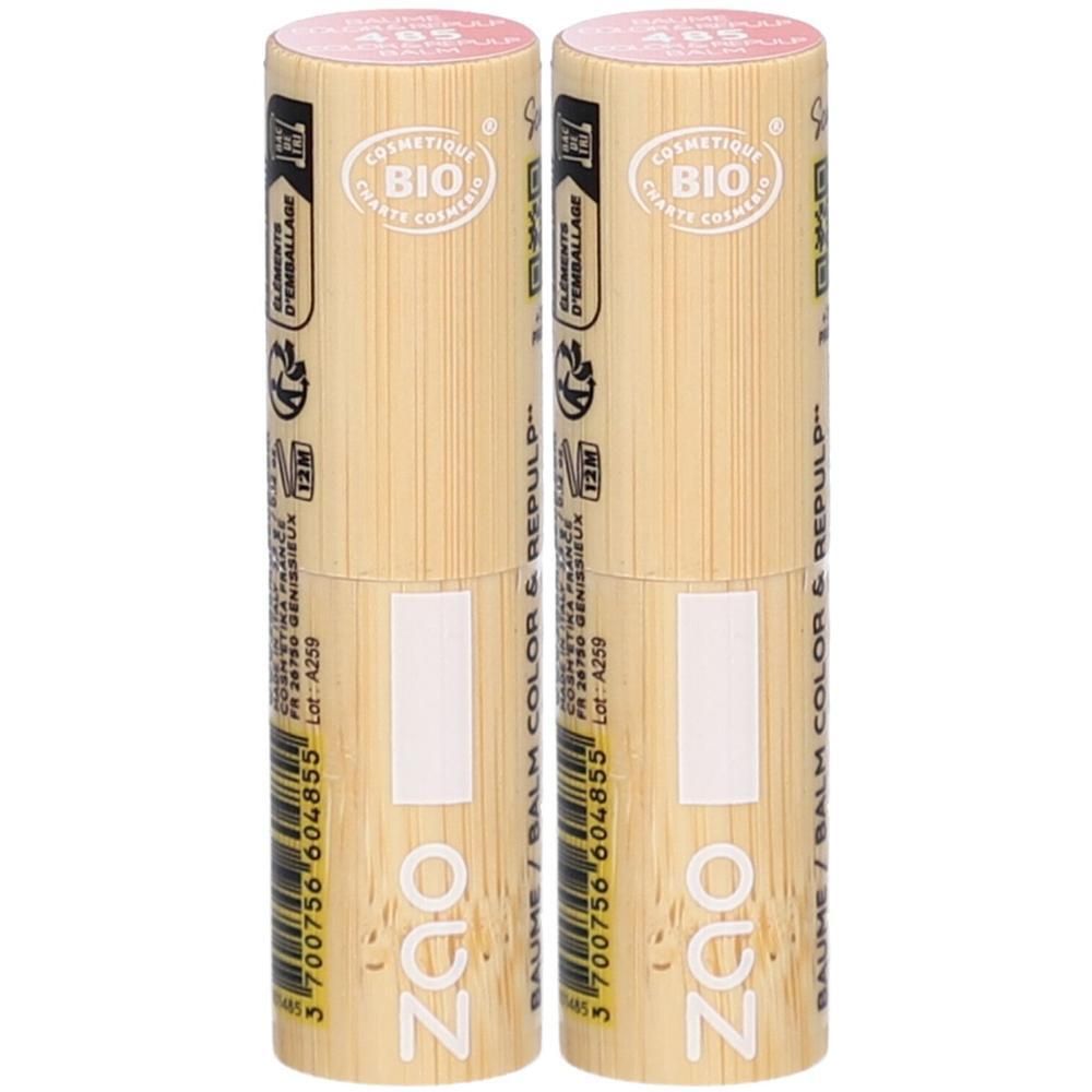 Deux baumes à lèvres. Emballage cylindrique en bois clair. Inscriptions : ZAO, COSMETIQUE BIO. Couvercle rose.