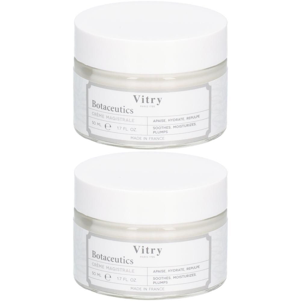 Deux pots de crème avec couvercles blancs. Étiquettes : "Vitry" et "Botaceutics". Texte : "CRÈME MAGISTRALE".