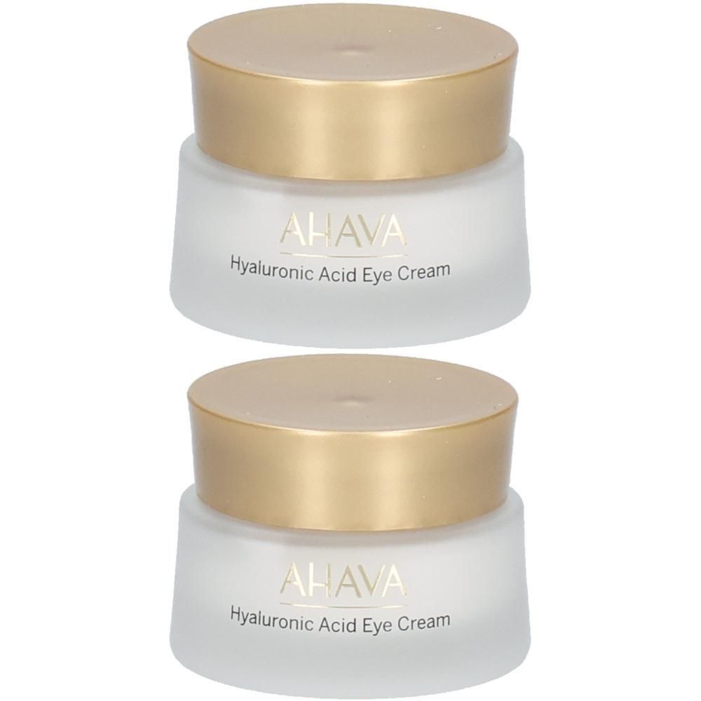 Deux pots de crème avec des couvercles dorés. On peut lire AHAVA et Hyaluronic Acid Eye Cream sur les pots.