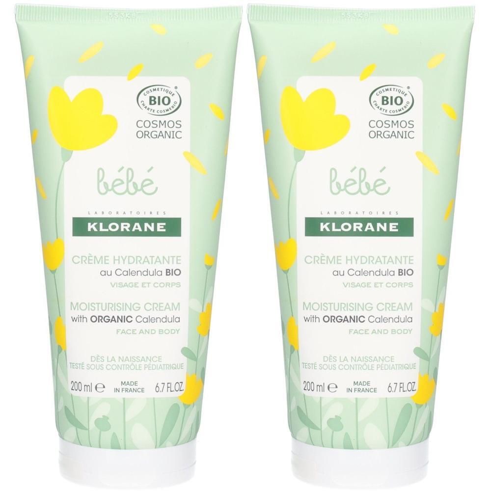Deux tubes de crème. Inscription: bébé, Klorane, Crème Hydratante au Calendula BIO. Certifié bio. Fond vert avec motifs floraux.
