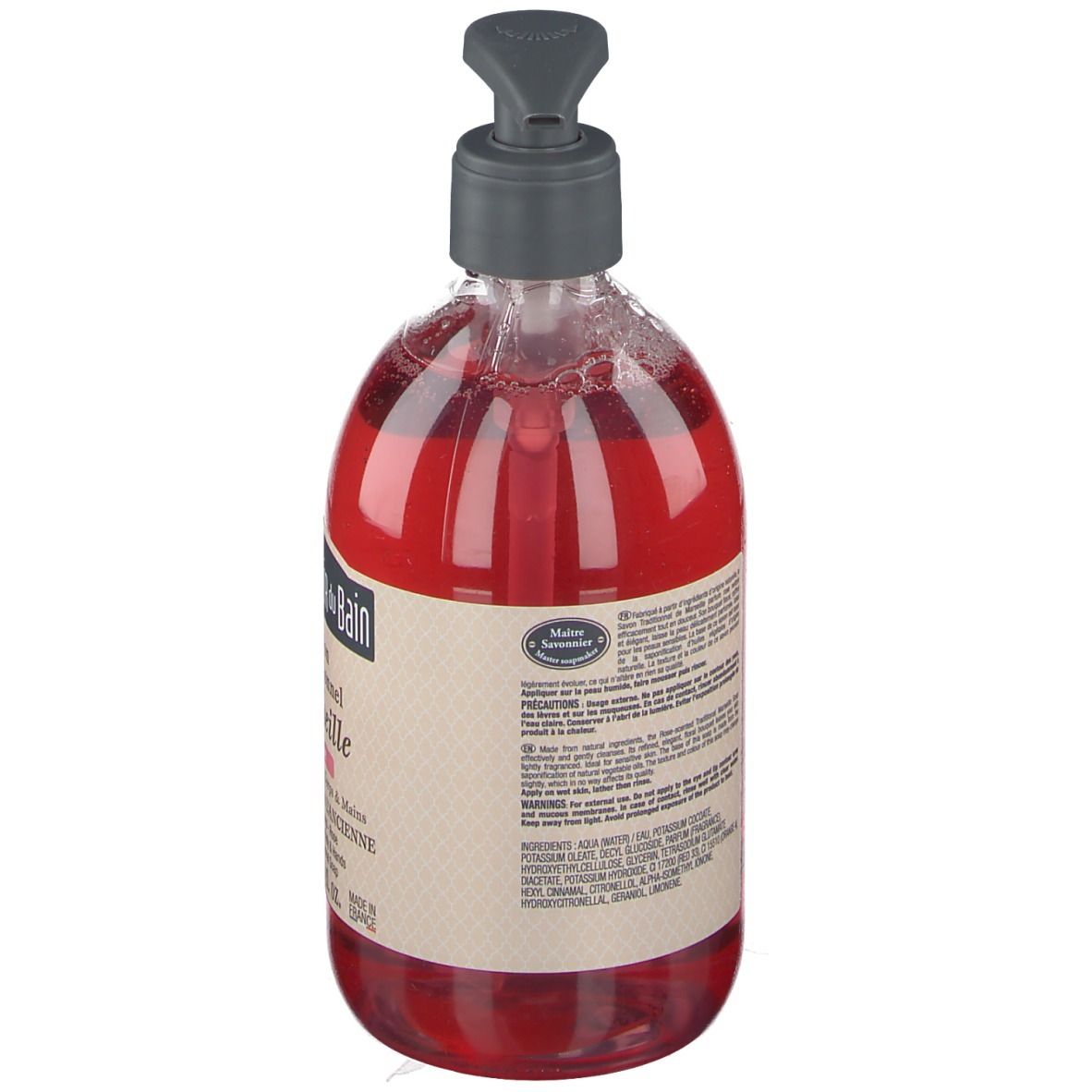 Vue arrière du savon liquide rouge dans un flacon transparent avec pompe. Texte sur l'étiquette.