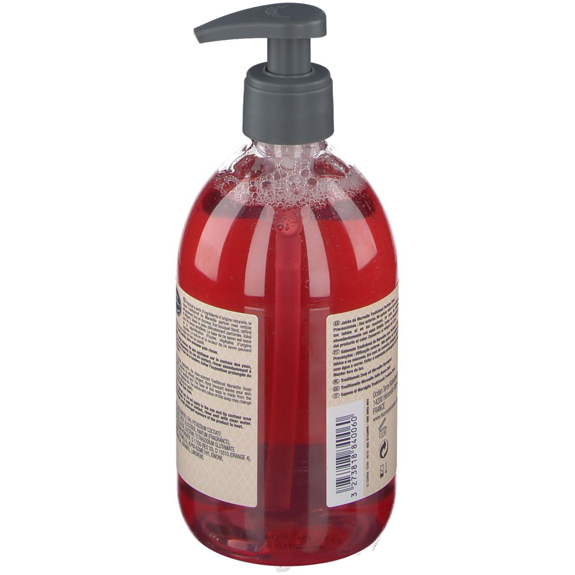 Vue arrière du savon liquide rouge dans un flacon transparent avec pompe. Texte sur l'étiquette.