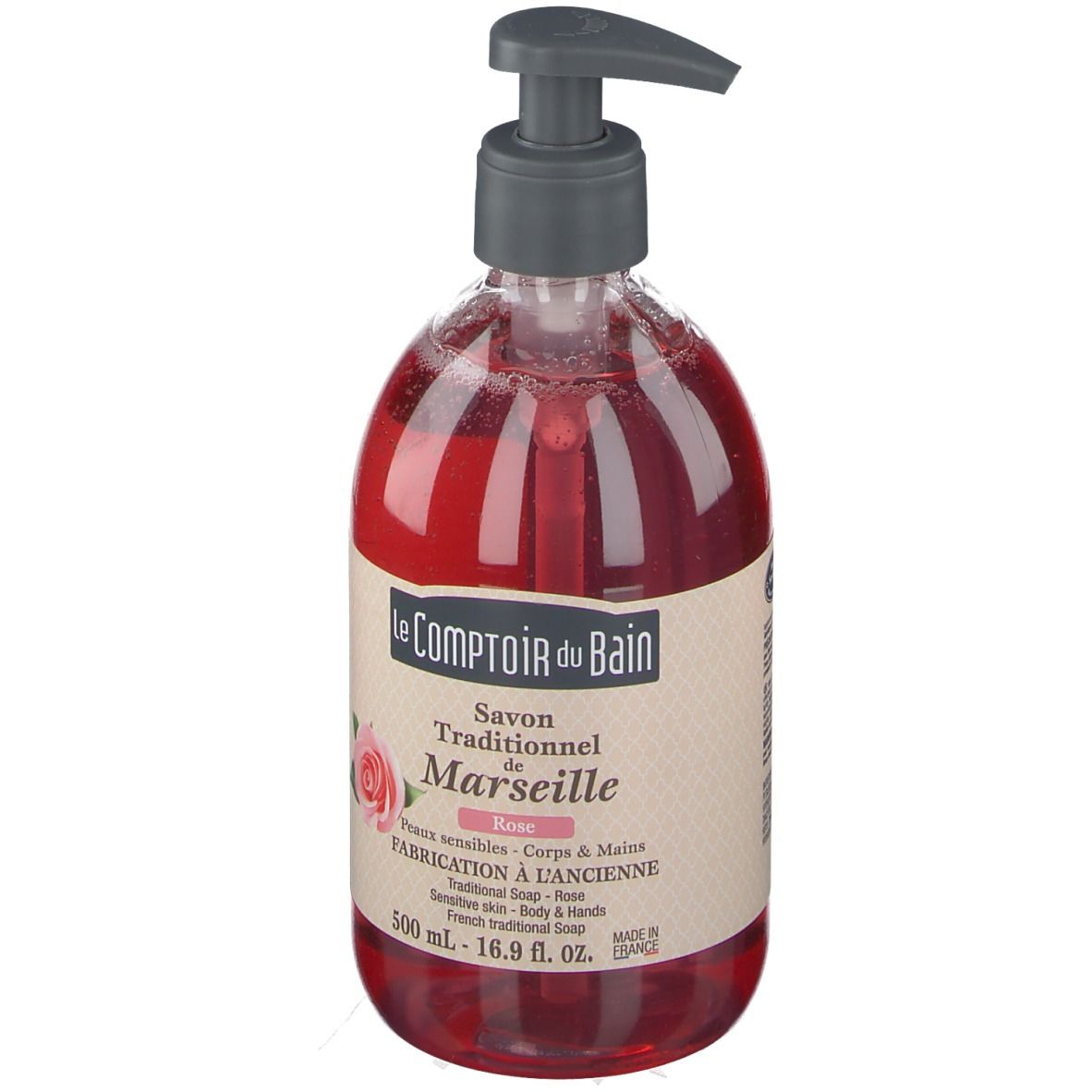 Savon liquide rouge dans un flacon transparent avec pompe. Inscription : Le Comptoir du Bain, Savon Traditionnel de Marseille Rose.