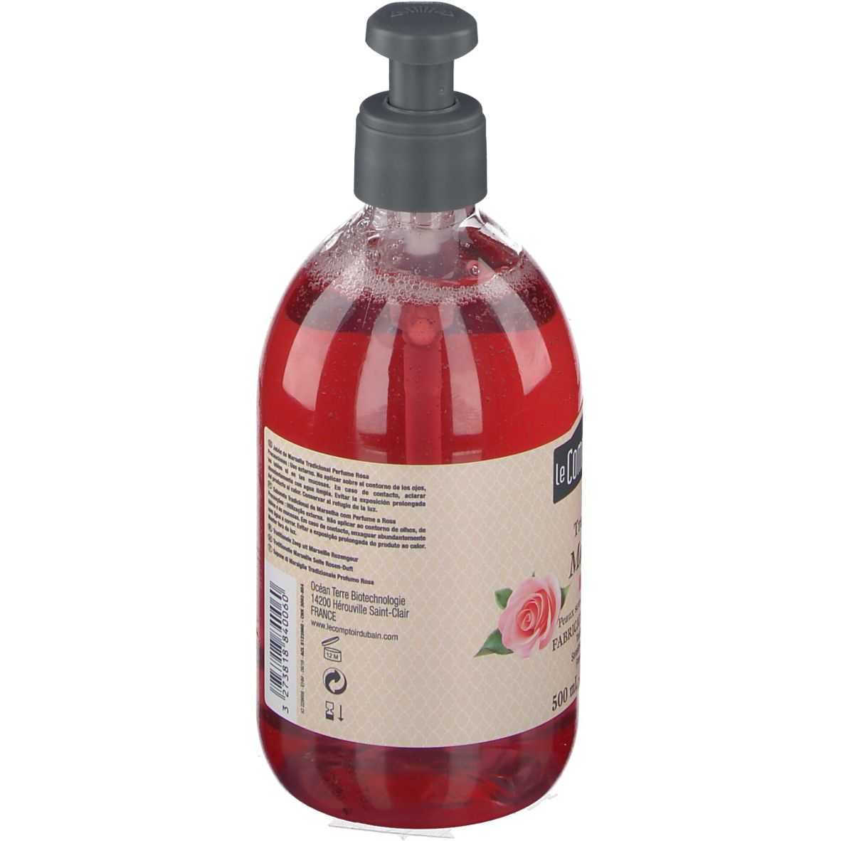 Vue arrière du savon liquide rouge dans un flacon transparent avec pompe. Texte sur l'étiquette.
